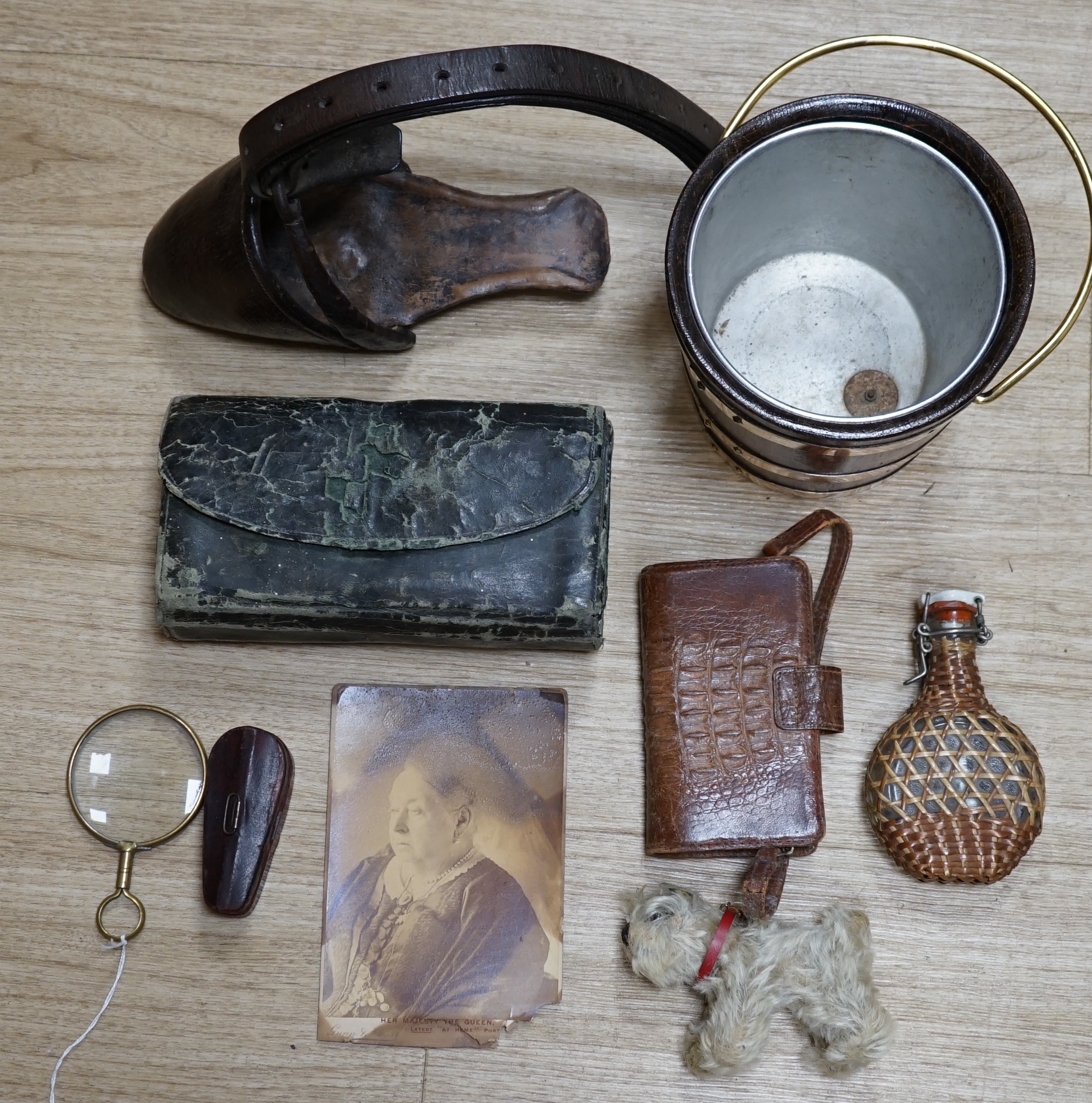 A collection of sundry items to include a fisherman's fly tying kit, a crocodile skin purse, a travelling inkwell, a miniature Steiff dog and a leather stirrup. etc. (9). Condition - mostly fair